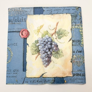 May include: A vintage-style napkin featuring a watercolor illustration of a bunch of purple grapes with green leaves on a yellow background. The napkin has a blue border with French text, including "aujolais" and "RERA".
