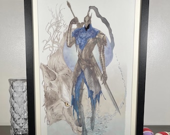 May include: Framed artwork featuring a watercolor illustration of a knight in silver armor with blue accents, holding a spear and sword. A wolf stands beside the knight. The artwork is in a black frame.