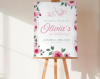 May include: A rectangular sign on a wooden easel featuring pink roses, green leaves, and a teapot illustration. The text reads: WELCOME TO THE PAR-TEA! Olivia's 1st birthday SATURDAY, APRIL 15TH #OLIVIASPARTEA. The design has a white center and pink border.