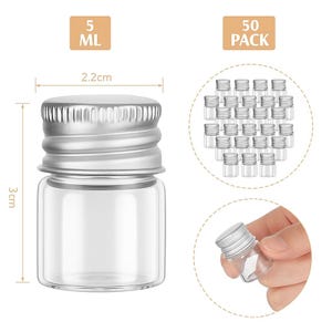 May include: Clear glass vials with silver screw-on caps. Each vial is 3 cm tall and 2.2 cm wide, with a 5 ml capacity. The image also shows a pack of 50 vials.