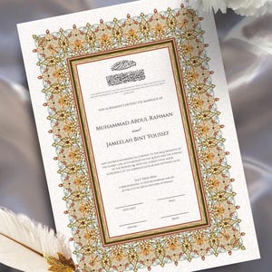 May include: A marriage certificate with ornate floral border in gold, green, and red. The document features Arabic calligraphy and the names Muhammad Abdul Rahman and Jameelah Bint Youssef. A decorative feather pen rests on the document.