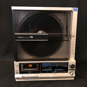 May include: Vintage white and black stereo system with a record player, cassette player, and radio. The record player has a clear cover and the text "DIATONE SETUP COMPO X7". The cassette player has the word "METAL" on it.