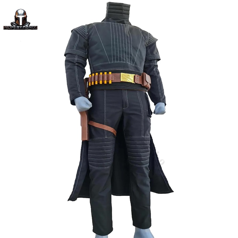 May include: A black costume with white stitching, featuring a high collar, long sleeves, and a long coat. The costume includes a brown belt with gold accents and a holster. The pants have knee padding. The costume is likely for cosplay or a themed event.
