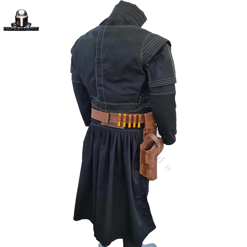 May include: Black costume with a hooded jacket, long skirt, and brown belt. The belt holds several yellow cylindrical objects and a brown holster. The costume has white stitching details and is likely for cosplay or themed events.