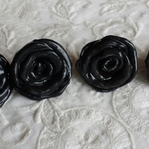 May include: Four black ceramic rose-shaped drawer pulls.