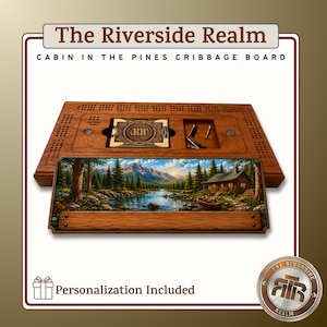 May include: A wooden cribbage board titled The Riverside Realm Cabin in the Pines. The board features a landscape print of a cabin by a lake, a recessed compartment for a deck of cards with the letters MW, and metal pegs for scoring the game.