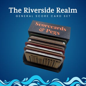 May include: A set of scorecards and pegs, with the text "The Riverside Realm" and "Scorecards & Pegs" in orange. The scorecards are in a black holder, with a blue background and white wave design at the bottom.