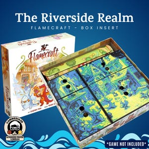 May include: A board game box insert for Flamecraft, featuring the text "The Riverside Realm." The box is white with colorful illustrations of dragons and buildings. The insert is divided into compartments with blue and green artwork. The text "*GAME NOT INCLUDED*" is visible.