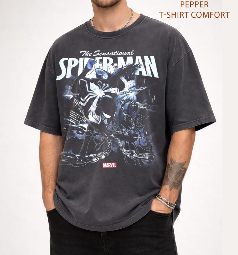 May include: Dark gray t-shirt featuring a graphic of Spider-Man with the text "The Sensational Spider-Man" and the Marvel logo. The shirt has a vintage, distressed look.