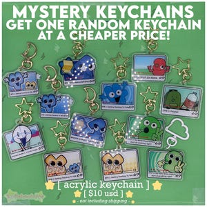 May include: A selection of acrylic keychains with cartoon character designs, each attached to a gold-coloured keyring. The keychains feature different shapes and designs, including stars and moons. Text on the keychains reads "MYSTERY KEYCHAINS" and "GET ONE RANDOM KEYCHAIN AT A CHEAPER PRICE!"