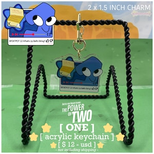 May include: A clear acrylic keychain featuring a blue cartoon character with a video player design. The keychain is 2 x 1.5 inches and includes the text "BFDETPOT 12: What's Up Bell's String?" and "Battle for Dream Island: The Power of Two [ONE] acrylic keychain".