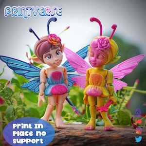 May include: Two fairy figurines with wings, dresses, and flower details. One fairy has blue and pink wings, the other has pink and yellow wings. The text "PRINTVERSE" is at the top, and "Print in Place no support" is at the bottom.