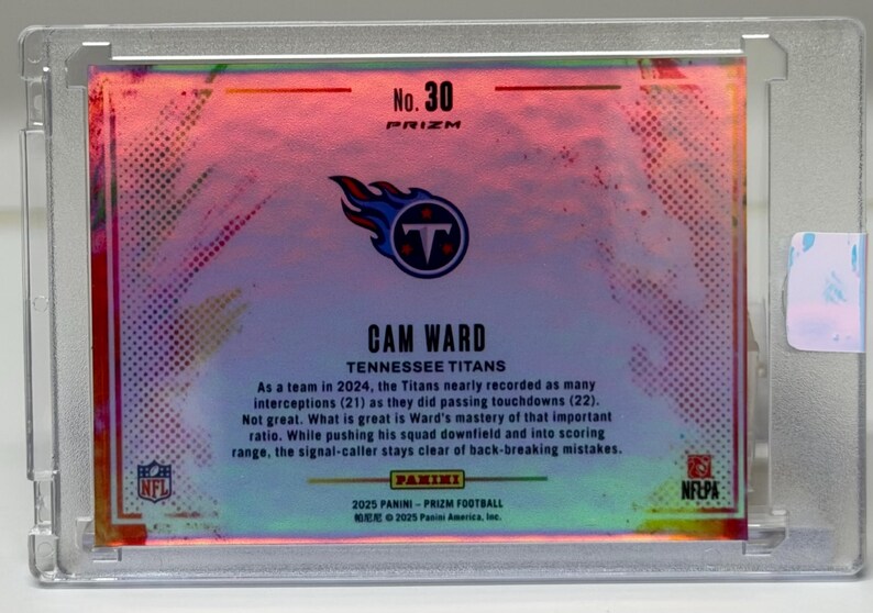 May include: A Cam Ward Tennessee Titans football card, encased in a clear protective holder. The card features the team logo and the text "No. 30 PRIZM". The card has a colorful, iridescent background with text describing the player's performance.