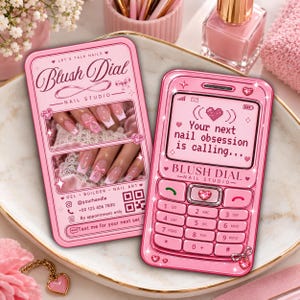 May include: Two rectangular pink business cards for Blush Dial Nail Studio. One card features photos of manicured nails with bows, contact info, and a QR code. The other card is shaped like a vintage mobile phone with a screen displaying the text Your next nail obsession is calling and a heart icon.