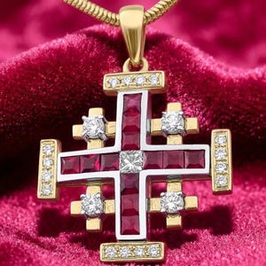 May include: A Jerusalem cross pendant crafted from gold and silver, featuring a central square diamond surrounded by channel-set square-cut red rubies. The cross arms are accented with round brilliant-cut diamonds and suspended from a gold chain.
