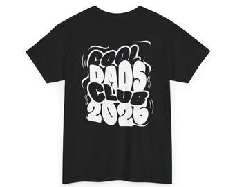 May include: Black t-shirt with the white text "Cool Dads Club 2026" in a bubble font. The text is surrounded by white swirls. The shirt has short sleeves and a crew neck.