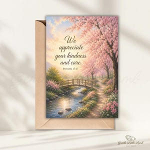 May include: A greeting card with a scenic landscape featuring a bridge over a river, lined with pink flowering trees. The card includes the text "We appreciate your kindness and care." and the Bible verse Proverbs 17:17. The card is inside a brown envelope.