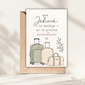 May include: A greeting card with the text "que Jehová te bendiga - en tu próxima aventura." The card features illustrations of three suitcases in green, beige, and tan, with a sprig of leaves and a heart. The card is inside a brown envelope.