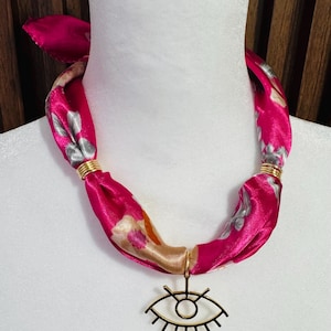 Pink silk scarf necklace with gold plated eye charm.
