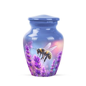 May include: A blue urn with a lid, featuring a bee hovering near lavender flowers. The urn has a glossy finish and a design that wraps around the body. The bee is yellow and black.