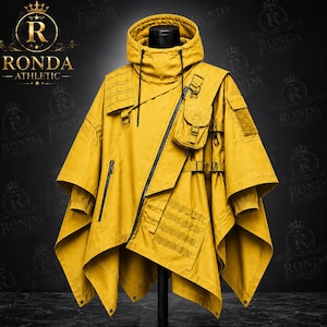 May include: A mustard yellow hooded poncho featuring a diagonal front zipper, an attached chest pocket, multiple utility straps, and ribbed cuffs. The garment displays the Ronda Athletic logo and text on the upper left side of the dark background.