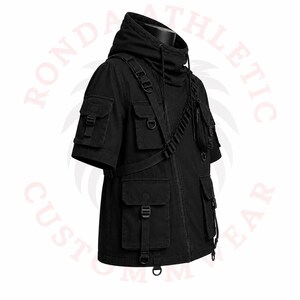 Cyberpunk black tactical jacket with utility pockets, hooded design, adjustable straps, and urban techwear fashion aesthetic.
