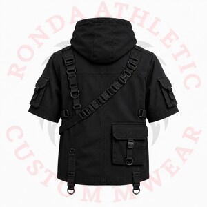 Men's black gothic techwear hoodie with multiple cargo pockets, tactical harness details, and futuristic streetwear styling.