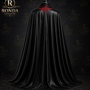 Luxury black velvet Dracula cape with red satin lining and embroidered Victorian suit for masquerade, steampunk events, and gothic fashion.