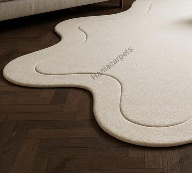 Transform your space with this Solid Off White Irregular Amoeba Shape Rug, a modern hand-tufted wool area rug designed to bring style, comfort, and uniqueness to your home. Crafted with a soft high pile texture, this rug creates a cozy and inviting feel underfoot, making it perfect for living rooms, bedrooms, nurseries, or kids’ play areas. Its off-white tone blends seamlessly with any interior style, from minimalist and Scandinavian to boho and contemporary décor.