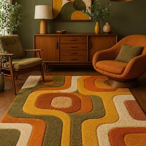 May include: A rectangular area rug featuring a high-pile texture with a repeating geometric pattern of rounded shapes in shades of burnt orange, mustard yellow, olive green, and cream, covering the floor in front of a wooden sideboard and chairs.