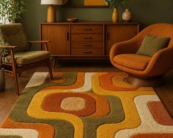 May include: A rectangular area rug featuring a high-pile texture with a repeating geometric pattern of rounded shapes in shades of burnt orange, mustard yellow, olive green, and cream, covering the floor in front of a wooden sideboard and chairs.