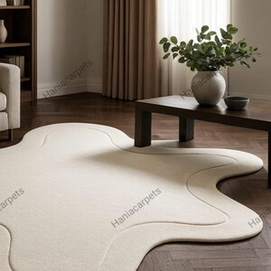 Transform your space with this Solid Off White Irregular Amoeba Shape Rug, a modern hand-tufted wool area rug designed to bring style, comfort, and uniqueness to your home. Crafted with a soft high pile texture, this rug creates a cozy and inviting feel underfoot, making it perfect for living rooms, bedrooms, nurseries, or kids’ play areas. Its off-white tone blends seamlessly with any interior style, from minimalist and Scandinavian to boho and contemporary décor.