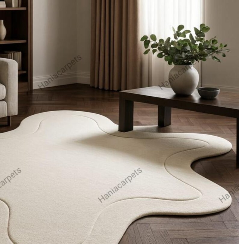 Transform your space with this Solid Off White Irregular Amoeba Shape Rug, a modern hand-tufted wool area rug designed to bring style, comfort, and uniqueness to your home. Crafted with a soft high pile texture, this rug creates a cozy and inviting feel underfoot, making it perfect for living rooms, bedrooms, nurseries, or kids’ play areas. Its off-white tone blends seamlessly with any interior style, from minimalist and Scandinavian to boho and contemporary décor.
