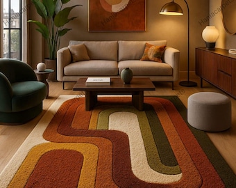 May include: A retro-style area rug with a wavy, layered design in shades of orange, brown, yellow, green, and cream. The rug is placed in a living room setting with a sofa, chair, and wooden coffee table. The room has a warm, inviting atmosphere.