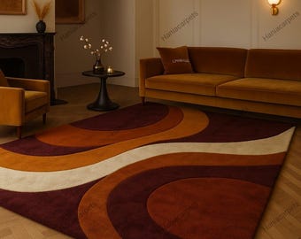 May include: A large, retro-style area rug with a wavy pattern in shades of burgundy, orange, and cream. The rug is placed in a living room setting with a matching sofa and armchair, creating a cohesive and warm atmosphere.