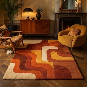 May include: A retro-style area rug with a geometric pattern in shades of orange, brown, and cream. The rug features a wavy design and a rectangular shape, suitable for a living room or similar space. The rug is placed on a wooden floor.