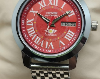 Montre-bracelet automatique Citizen pour homme en acier inoxydable avec jour/date, chiffres ronds et cadran rouge