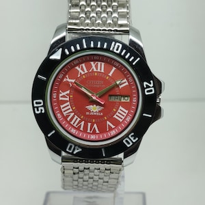 Reloj de buceo Citizen automático para hombre, 21 joyas, esfera romana roja, día/fecha, bisel giratorio.