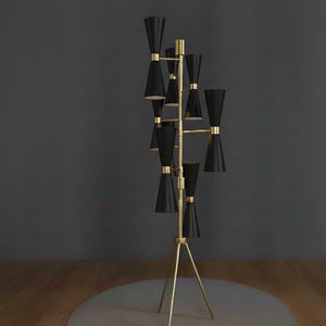 May include: A tall, mid-century modern floor lamp with a brass finish and black cone-shaped shades. The lamp has a tripod base and multiple light sources, creating a stylish and functional lighting fixture. The design is sleek and elegant.