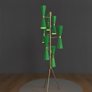 May include: A modern floor lamp with a brass frame and multiple green cone-shaped shades. The lamp has a tripod base and stands approximately 60 inches tall, providing ambient lighting with its unique design.