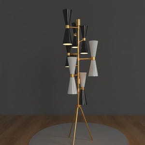 May include: A modern floor lamp with a gold-colored tripod base and a vertical structure. The lamp features multiple black and white cone-shaped shades, arranged in a tiered design. The lamp is a stylish lighting fixture.