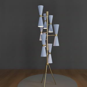 May include: A modern floor lamp with a brass frame and multiple light blue cone-shaped shades. The lamp has a tripod base and a series of lights arranged vertically. The design is sleek and contemporary, suitable for home decor.