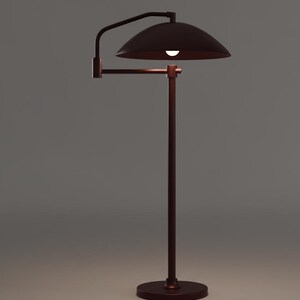 May include: A bronze floor lamp with a curved arm and a dome-shaped shade. The lamp has a circular base and a vertical pole supporting the arm and shade. The light is on, illuminating the shade's interior.