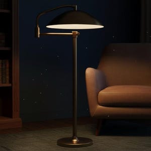 May include: A black floor lamp with a curved arm and a wide, dome-shaped shade. The lamp has a brass-coloured base and a warm, inviting glow. The lamp is next to a brown armchair.