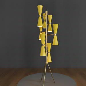 May include: A tall, mid-century modern floor lamp with a brass frame and multiple yellow cone-shaped shades. The lamp has a tripod base and a series of horizontal bars supporting the shades. The shades are arranged in a vertical, staggered pattern.