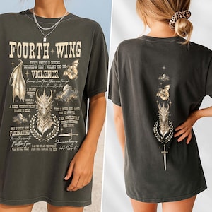 May include: A charcoal gray t-shirt featuring a graphic print of a dragon, wings, and a sword. The front displays the text "FOURTH WING" and "VIOLENCE" with additional quotes. The back features a vertical design of a dragon head, sword, and clouds.