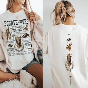 May include: An off-white crewneck sweatshirt and t-shirt featuring Fourth Wing book graphics. The front displays the text Fourth Wing, dragon illustrations, and quotes. The back features a vertical design with a star, clouds, a dragon, and a sword.
