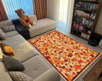 Alfombra otoñal con hojas de arce para sala de estar: suave y antideslizante, en tonos naranja y rojo cálidos.