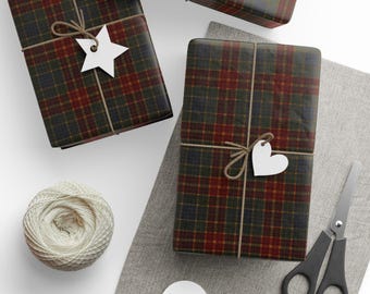 May include: Three wrapped gifts with a plaid pattern in shades of green, red, and brown, tied with twine and adorned with white paper tags. A ball of twine, scissors, and additional tags are also visible.