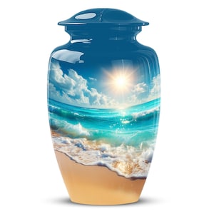 May include: A blue cremation urn with a glossy finish. The urn features a scenic beach design with a bright sun, blue sky, and ocean waves. The bottom of the urn is tan, resembling sand.